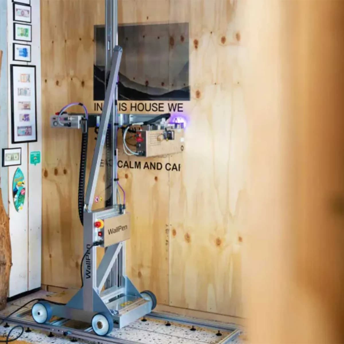 WallPen robot printing inspirational quote on wooden wall by InnoPrint KSA